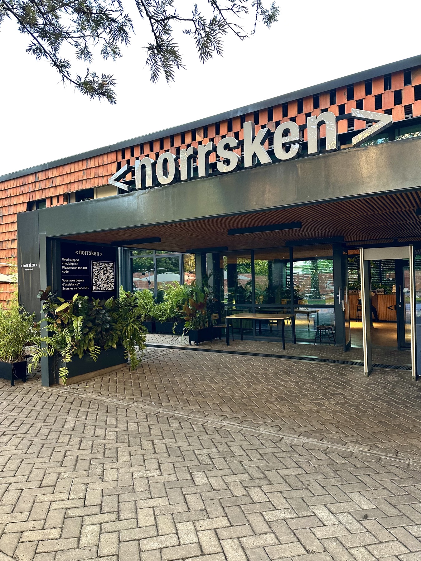 The patterned brick and metal entrance of the Norrsken workspace in Kigali